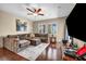 Spacious living room with hardwood floors, a ceiling fan, and natural light from the windows at 10312 Glimmering Star Dr, Las Vegas, NV 89178