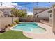 Sparkling pool and spa with manicured lawn, surrounded by a patio perfect for relaxation and outdoor gatherings at 11484 Roncat Ct, Las Vegas, NV 89141