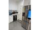 Charming kitchen with stainless steel refrigerator and bar area at 1525 Spiced Wine Ave # 14101, Henderson, NV 89074