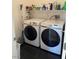 Functional laundry room with side-by-side washer and dryer with shelf storage above at 1525 Spiced Wine Ave # 14101, Henderson, NV 89074