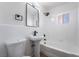 Modern bathroom featuring a pedestal sink, toilet, and shower-tub combo with modern fixtures and lighting at 2 Utah Way, Henderson, NV 89015