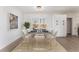 Bright dining area boasts modern table, elegant chairs, and sliding glass doors to the patio at 2 Utah Way, Henderson, NV 89015