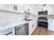Bright kitchen showcases white cabinets, stainless steel appliances, and elegant marble countertops at 2 Utah Way, Henderson, NV 89015