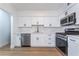 Modern kitchen featuring white cabinets, stainless steel appliances, and sleek countertops at 2 Utah Way, Henderson, NV 89015
