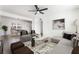 Spacious living room featuring modern decor, open concept design and a view into the dining area at 2 Utah Way, Henderson, NV 89015