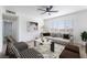 Bright living room with stylish furnishings, modern ceiling fan, and a large window offering natural light at 2 Utah Way, Henderson, NV 89015