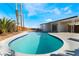 Backyard pool with a view of the house and patio under a bright blue sky with fluffy clouds at 2 Utah Way, Henderson, NV 89015