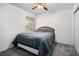 Simple bedroom with neutral walls, carpet flooring, a queen bed with gray bedding, and a window with blinds at 218 Red Coral Dr, Henderson, NV 89002