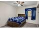 Bright bedroom featuring a queen bed with blue bedding, a window with blue curtains, and carpet flooring at 218 Red Coral Dr, Henderson, NV 89002