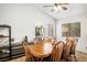 Bright dining room featuring a wood table with seating for eight, shelving, and natural light from two windows at 218 Red Coral Dr, Henderson, NV 89002