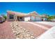 Charming single-story home with a well-maintained front yard and a two-car garage at 218 Red Coral Dr, Henderson, NV 89002