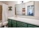 Bathroom with modern green cabinets, white countertop and a large mirror at 2200 S Fort Apache Rd # 2217, Las Vegas, NV 89117