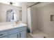 Stylish bathroom with modern vanity, elegant mirror, and a tiled walk-in shower with a white curtain at 2200 S Fort Apache Rd # 2217, Las Vegas, NV 89117
