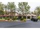 Clubhouse with stucco walls, a tile roof, arched entrances, and several palm trees in front at 2200 S Fort Apache Rd # 2217, Las Vegas, NV 89117