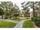 Well-maintained grounds with a putting green, benches, and walking paths surrounded by mature trees at 2200 S Fort Apache Rd # 2217, Las Vegas, NV 89117