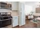 Charming kitchen with stainless steel appliances, blue cabinetry, and convenient access to the dining area at 2200 S Fort Apache Rd # 2217, Las Vegas, NV 89117