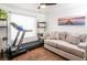 Bright living room featuring a comfortable couch and exercise equipment at 2200 S Fort Apache Rd # 2217, Las Vegas, NV 89117