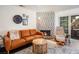 Inviting living room features a cozy fireplace, modern leather sofa, and sliding door access to the outdoors at 2200 S Fort Apache Rd # 2217, Las Vegas, NV 89117