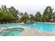 Community pool with waterfall feature, surrounding lounge chairs, umbrellas, and palm trees at 2200 S Fort Apache Rd # 2217, Las Vegas, NV 89117