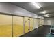 Indoor racquetball court with glass doors, wooden floors, and lights with seating alongside at 2200 S Fort Apache Rd # 2217, Las Vegas, NV 89117