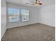 Well-lit bedroom with carpet floors, a ceiling fan, and dual windows at 2261 Dalton Ridge Ct, North Las Vegas, NV 89031