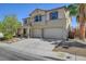 Charming two-story home featuring a spacious three-car garage and a well-maintained front yard at 2261 Dalton Ridge Ct, North Las Vegas, NV 89031