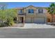 Charming two-story home featuring a spacious three-car garage and a well-maintained front yard at 2261 Dalton Ridge Ct, North Las Vegas, NV 89031