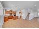 Open concept kitchen with wood cabinetry, granite countertops, and a center island with bar seating at 2261 Dalton Ridge Ct, North Las Vegas, NV 89031