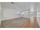 Spacious living room with neutral carpet, white walls, and ample natural light from large windows at 2261 Dalton Ridge Ct, North Las Vegas, NV 89031