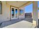 Covered patio featuring concrete flooring and white framed glass paneled doors to the home's interior at 2261 Dalton Ridge Ct, North Las Vegas, NV 89031