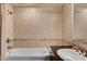 Bathroom featuring tiled walls, a vanity with a sink, and a shower-tub combo at 2405 W Serene Ave # 612, Las Vegas, NV 89123