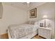 Cozy bedroom with neutral decor, a comfortable bed, and a side table with a lamp at 2405 W Serene Ave # 612, Las Vegas, NV 89123