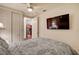 Bedroom with a ceiling fan, TV, closet and view into the kitchen at 2405 W Serene Ave # 612, Las Vegas, NV 89123