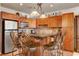 Kitchen with stainless steel appliances, wood cabinetry, and eat-in bar with seating at 2405 W Serene Ave # 612, Las Vegas, NV 89123