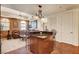 A kitchen island with a granite countertop and barstool seating, seamlessly connected to the living area at 2405 W Serene Ave # 612, Las Vegas, NV 89123