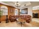 Stylish living room boasting a leather couch, arch windows, decorative art and access to the bedroom at 2405 W Serene Ave # 612, Las Vegas, NV 89123