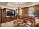 Inviting living room featuring a comfortable leather couch, decorative cabinet, and ample natural light at 2405 W Serene Ave # 612, Las Vegas, NV 89123