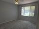 Bedroom with gray walls and carpets, and a window overlooking the parking lot at 2900 Sunridge Heights Pkwy # 418, Henderson, NV 89052