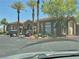 Exterior of community clubhouse with golf carts parked and mature palm trees at 2900 Sunridge Heights Pkwy # 418, Henderson, NV 89052
