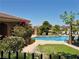 Community pool area with lounge chairs, lush landscaping, and well-maintained grounds at 2900 Sunridge Heights Pkwy # 418, Henderson, NV 89052