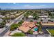 Scenic aerial view showcases a charming home with a pool and well-maintained landscaping in a quiet residential neighborhood at 3085 Duneville St, Las Vegas, NV 89146
