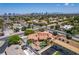 Beautiful aerial shot of a home with a refreshing pool, lush landscaping, and a view of the distant city skyline at 3085 Duneville St, Las Vegas, NV 89146