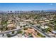Panoramic aerial showcasing a home amidst a suburban landscape, with a stunning cityscape visible in the distance at 3085 Duneville St, Las Vegas, NV 89146