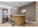 Stylish home bar area with custom stonework, seating, and mirror at 3085 Duneville St, Las Vegas, NV 89146