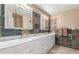 Stylish bathroom featuring a white vanity with marble countertops and decorative tile backsplash at 3085 Duneville St, Las Vegas, NV 89146