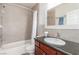 Bathroom featuring neutral tile, a shower over tub, and a vanity with dark wood cabinets at 3085 Duneville St, Las Vegas, NV 89146