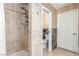 Bathroom with a tiled walk-in shower and tiled accent wall at 3085 Duneville St, Las Vegas, NV 89146