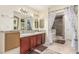Bathroom with double sinks, granite countertops, and a shower with decorative tile at 3085 Duneville St, Las Vegas, NV 89146