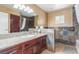 Charming bathroom with a vanity, granite countertop, and tiled walls at 3085 Duneville St, Las Vegas, NV 89146