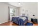 Bright bedroom with hardwood floors, a queen-sized bed, and a window overlooking the outdoors at 3085 Duneville St, Las Vegas, NV 89146